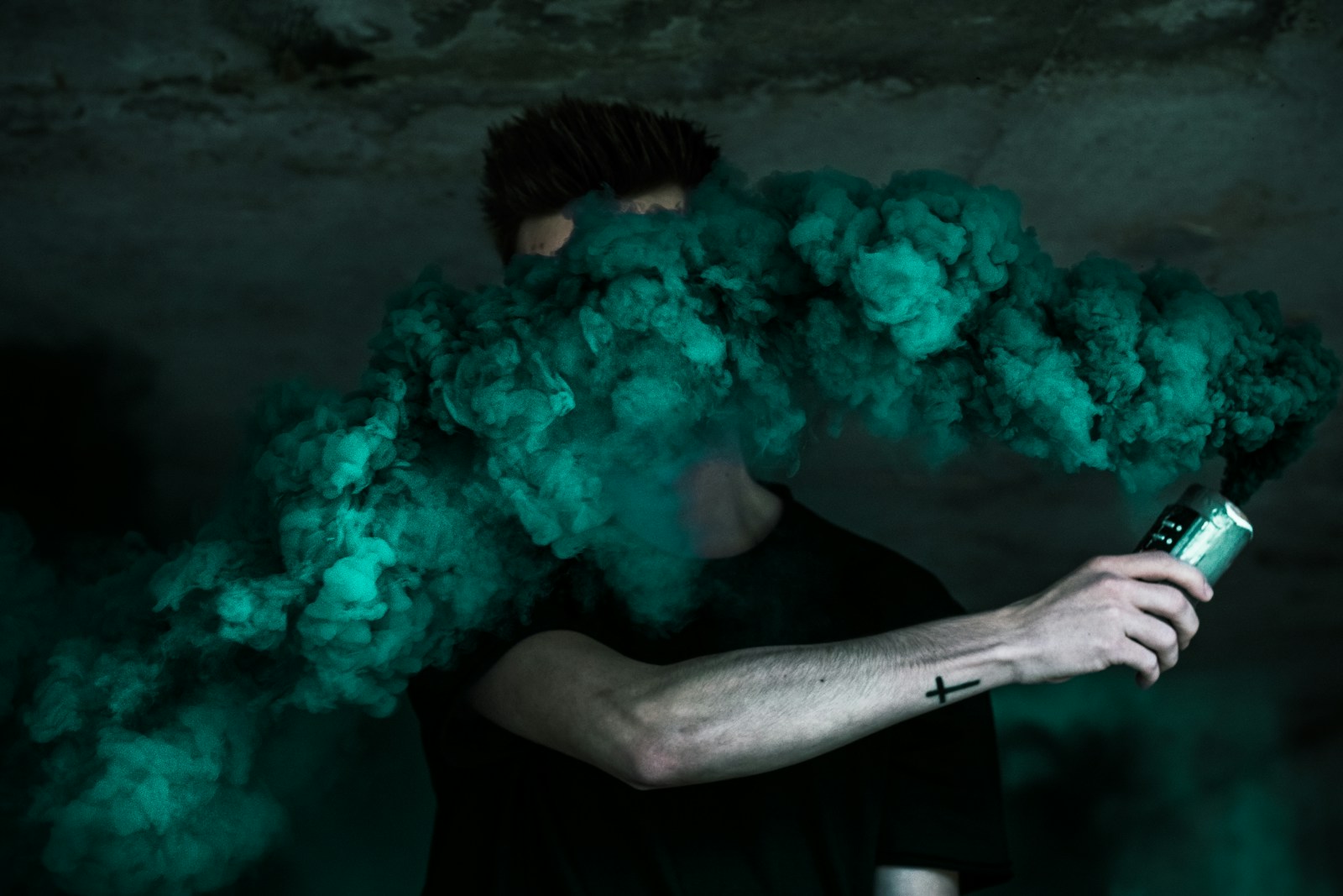 man holding can with smoke to symbolize a blowout.