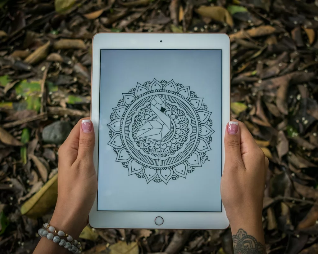 white iPad Pro showing a geometric mandala tattoo